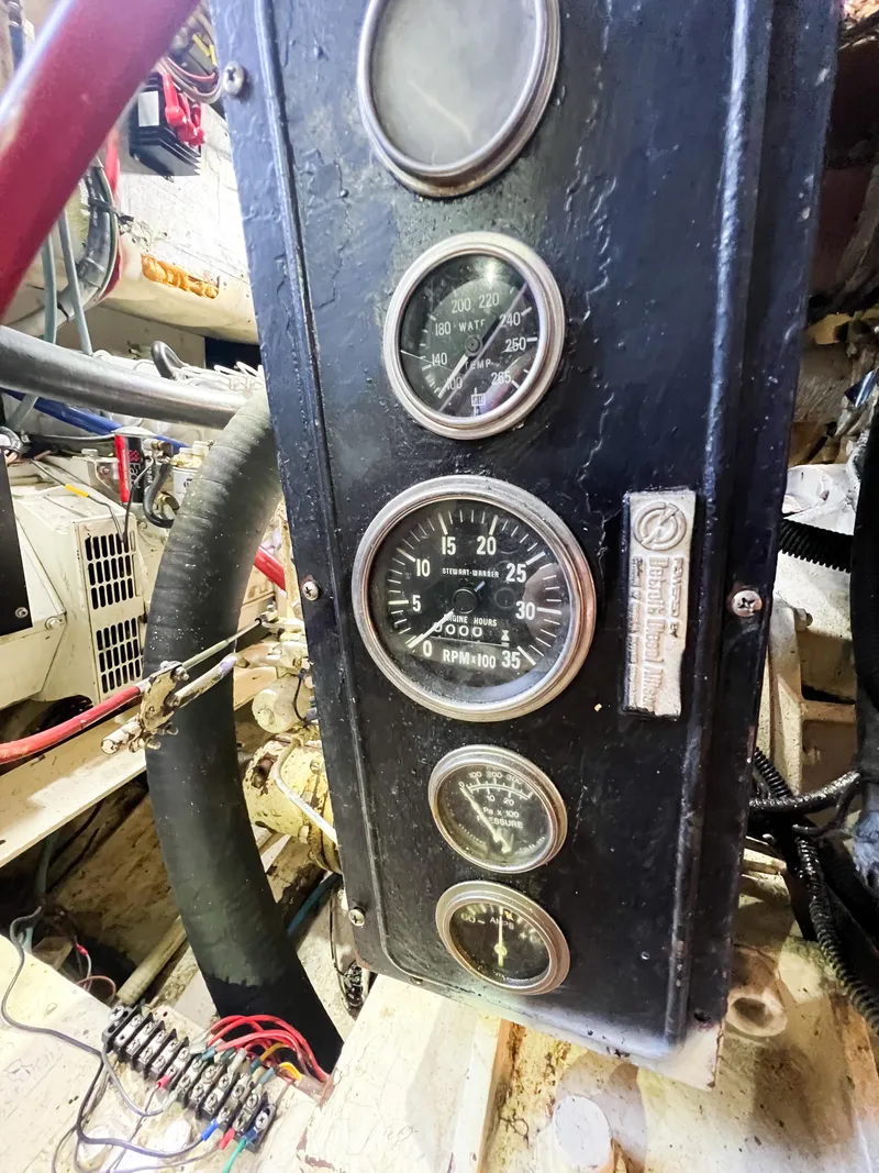 Slide: The Image of Control panel with gauges in a 1987 Buddy Davis 61 Convertible boat. - 28