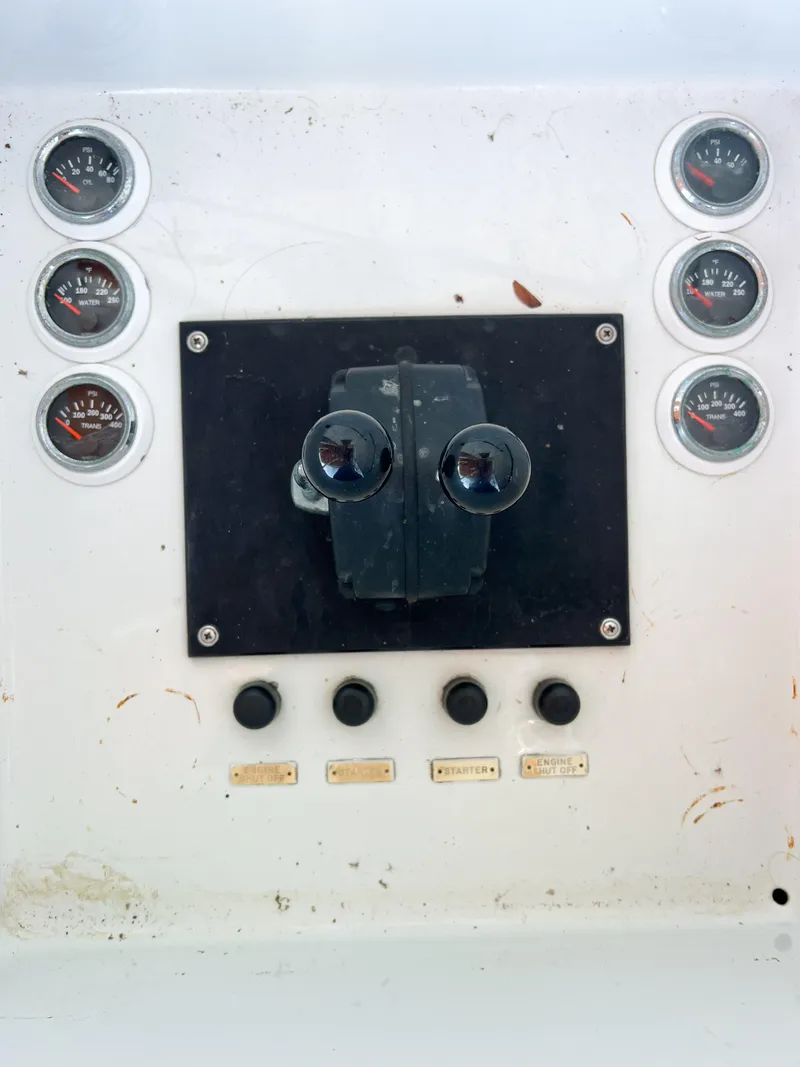Slide: The Image of Control panel of a 1987 Buddy Davis 61 Convertible boat with gauges and switches. - 30