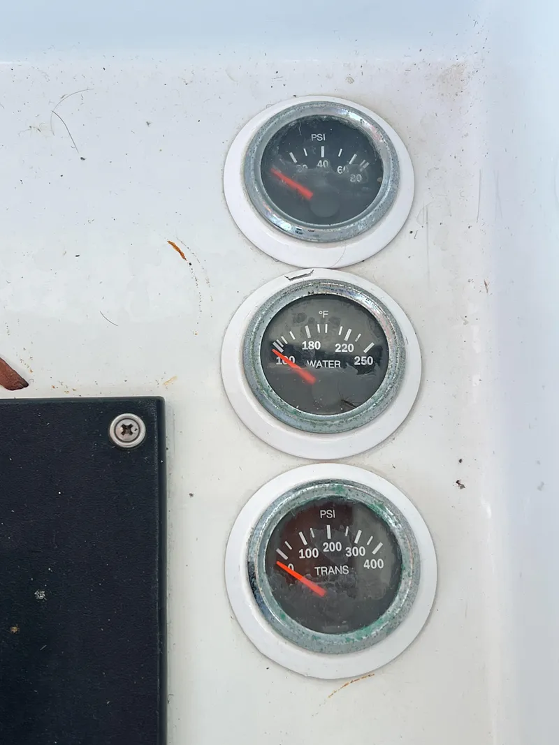 Slide: The Image of Gauges on 1987 Buddy Davis 61 Convertible boat dashboard, displaying PSI and temperature readings. - 31