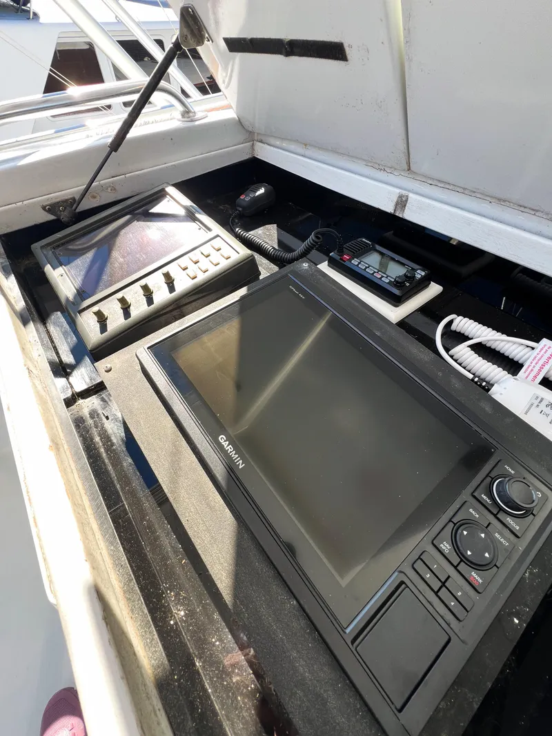 Slide: The Image of Control panel of a 1987 Buddy Davis 61 Convertible boat with navigation equipment. - 34