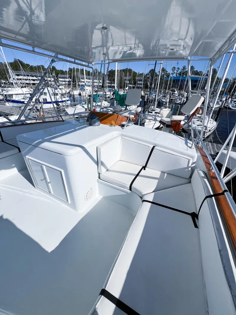 Slide: The Image of 1987 Buddy Davis 61 Convertible yacht with spacious deck at marina. - 36