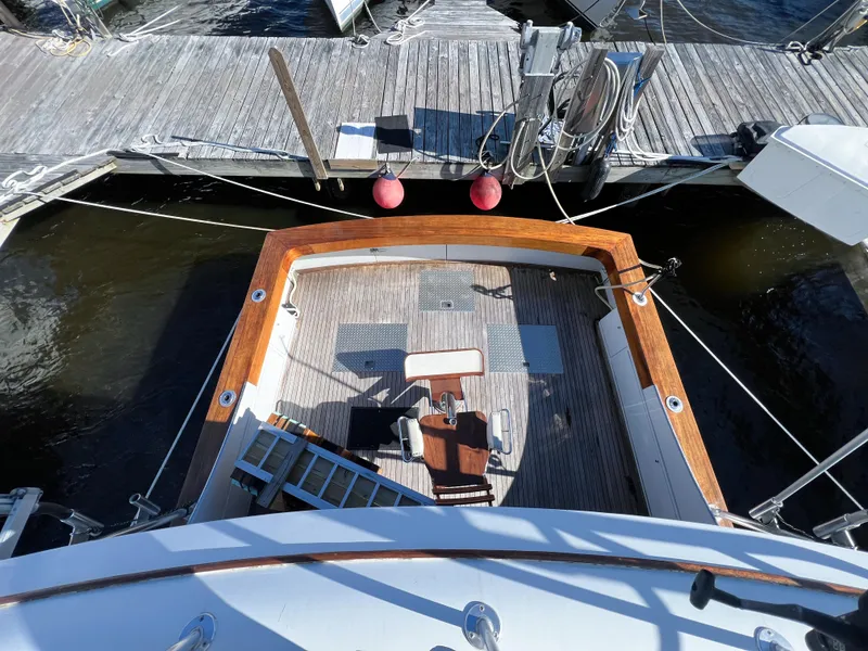 Slide: The Image of 1987 Buddy Davis 61 Convertible yacht deck with wooden trim, docked at marina. - 41