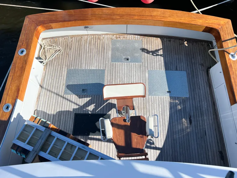 Slide: The Image of 1987 Buddy Davis 61 Convertible yacht deck with fishing chair and wooden trim. - 42