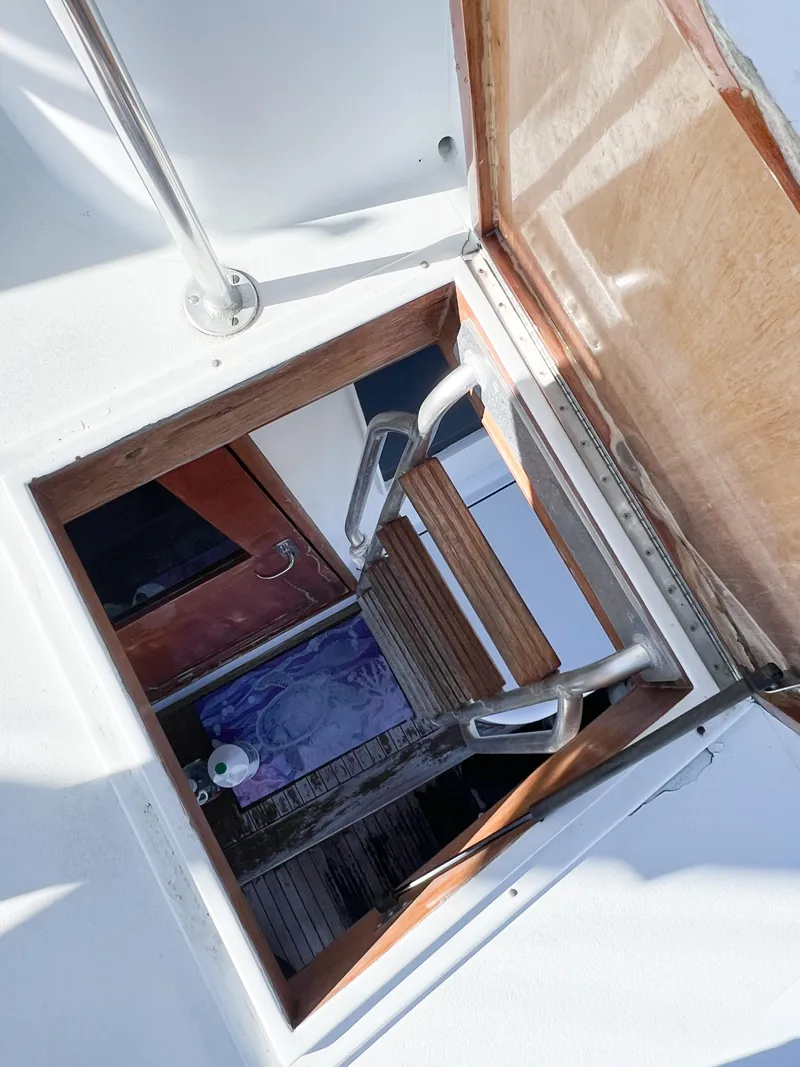 Slide: The Image of Open hatch on 1987 Buddy Davis 61 Convertible yacht, showing interior stairs and wooden details. - 43