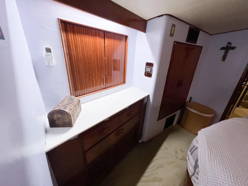 Slide: The Image of Interior of 1987 Buddy Davis 61 Convertible yacht with wooden cabinets and white countertop. - 48