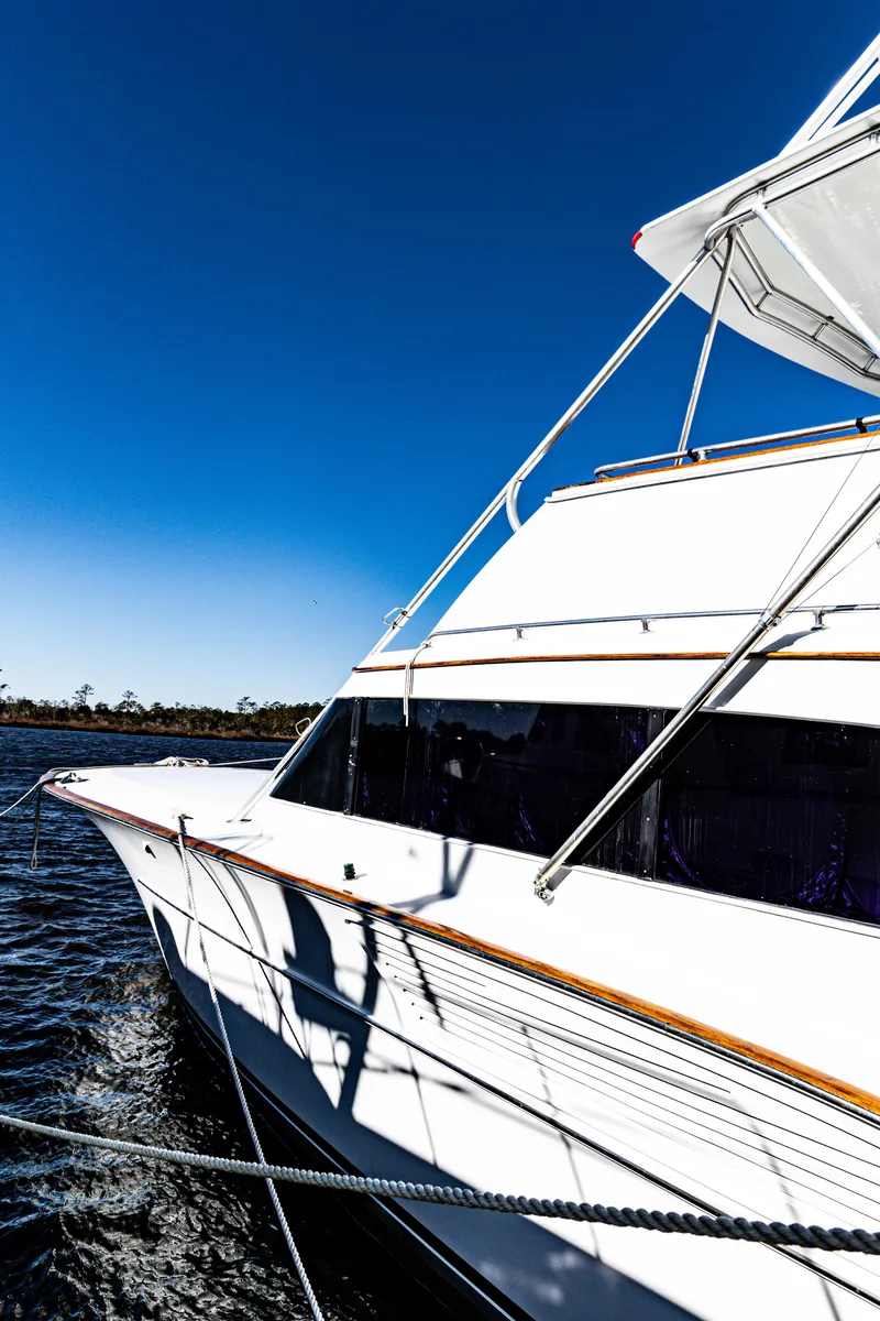 Slide: The Image of 1987 Buddy Davis 61 Convertible yacht on water under clear blue sky. - 5