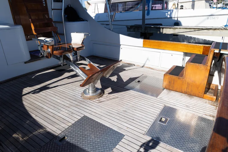 Slide: The Image of 1987 Buddy Davis 61 Convertible yacht deck with fishing chair and wooden flooring. - 8