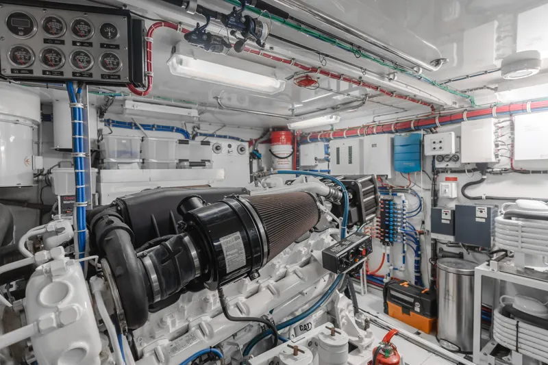 Slide: The Image of Engine room of 2006 Hatteras 80 Motor Yacht, featuring complex machinery and control panels. - 14