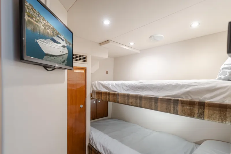 Slide: The Image of Interior of 2006 Hatteras 80 Motor Yacht with bunk beds and wall-mounted TV. - 17