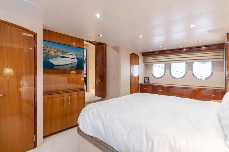 Slide: The Image of Luxurious bedroom interior of 2006 Hatteras 80 Motor Yacht with elegant wood finishes. - 21