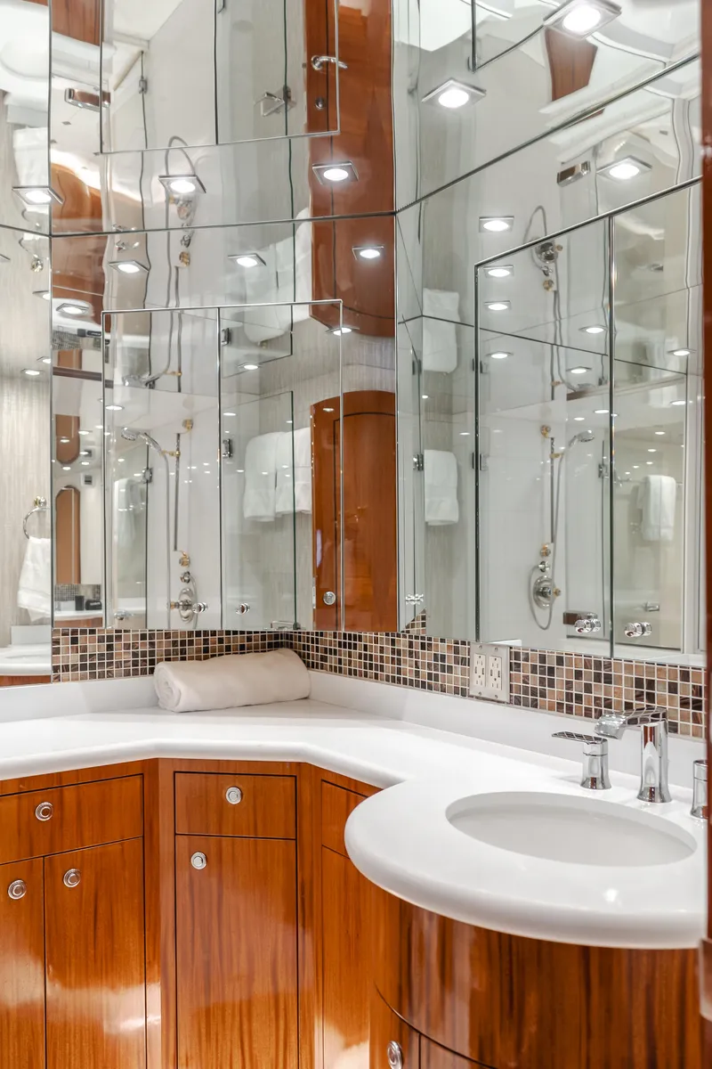 Slide: The Image of Luxurious bathroom in 2006 Hatteras 80 Motor Yacht with mirrored walls and elegant fixtures. - 25