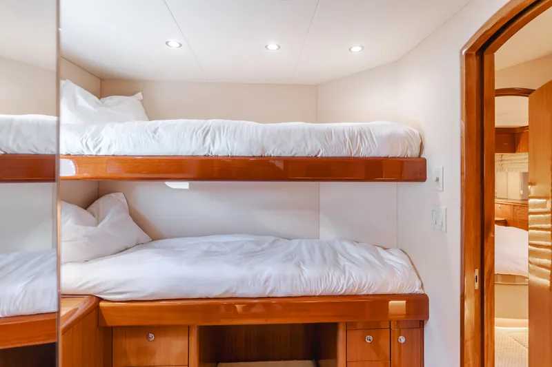 Slide: The Image of Bunk beds in 2006 Hatteras 80 Motor Yacht cabin, featuring wooden finishes and cozy bedding. - 33