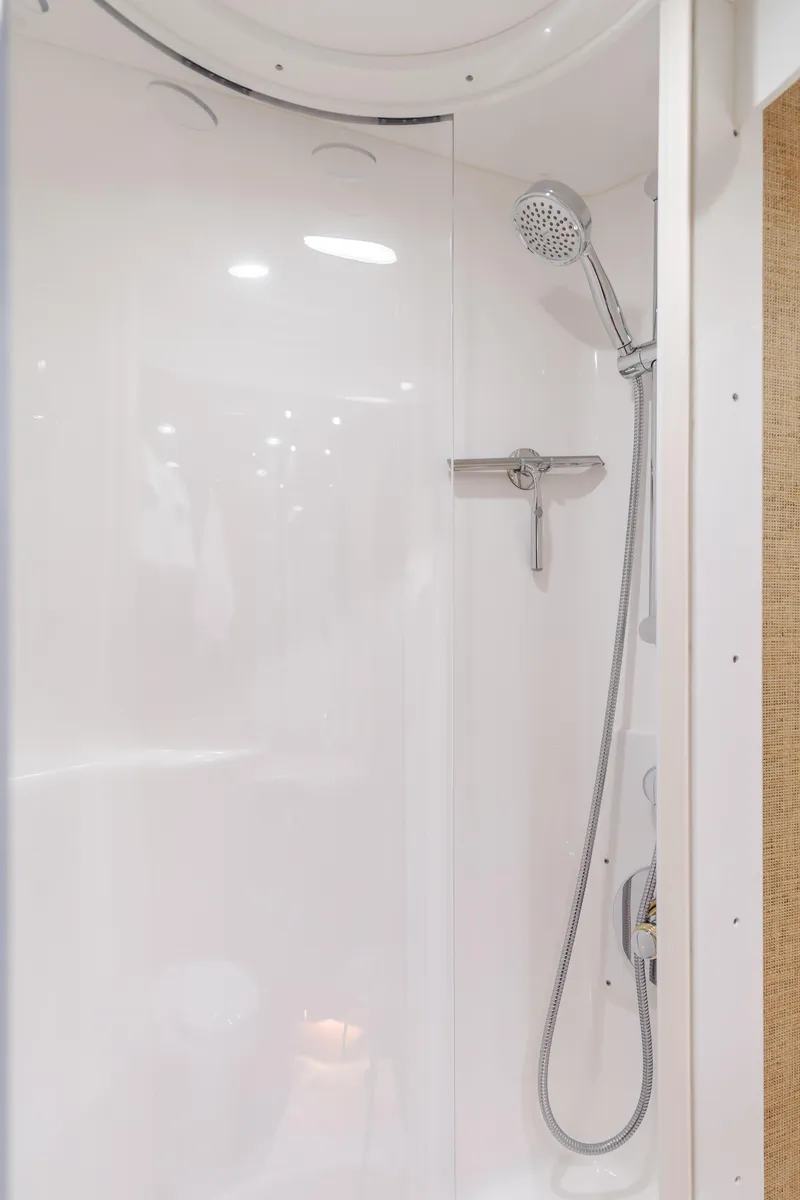 Slide: The Image of Shower area in 2006 Hatteras 80 Motor Yacht, featuring sleek white design and modern fixtures. - 35