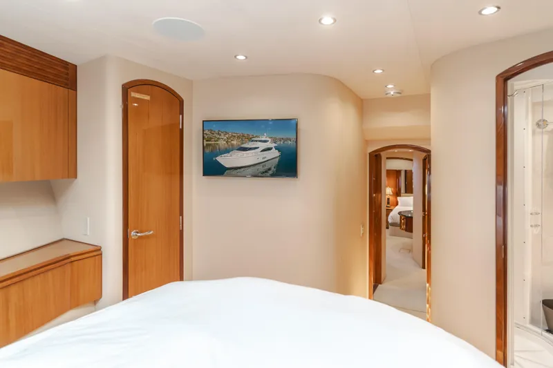 Slide: The Image of Interior of 2006 Hatteras 80 Motor Yacht, featuring a cozy bedroom and hallway. - 37