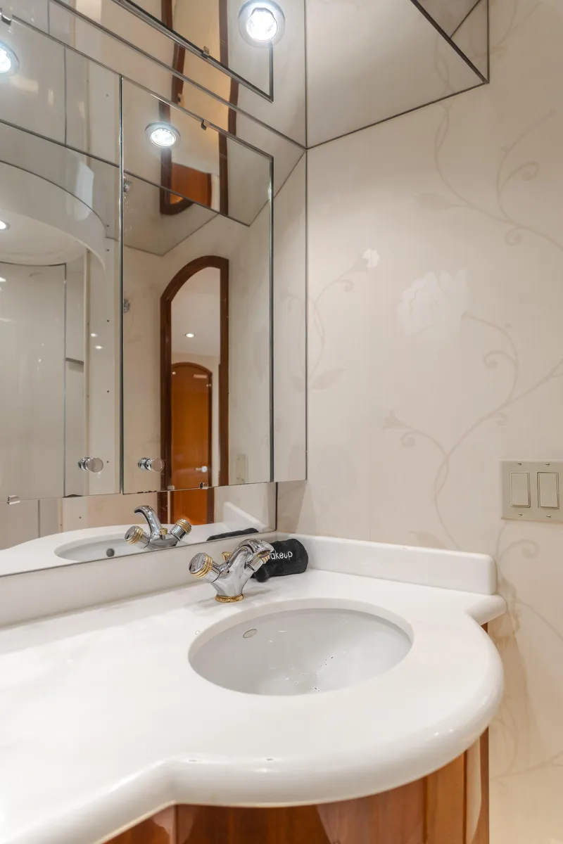 Slide: The Image of Luxurious bathroom in 2006 Hatteras 80 Motor Yacht with elegant fixtures and mirrored walls. - 38