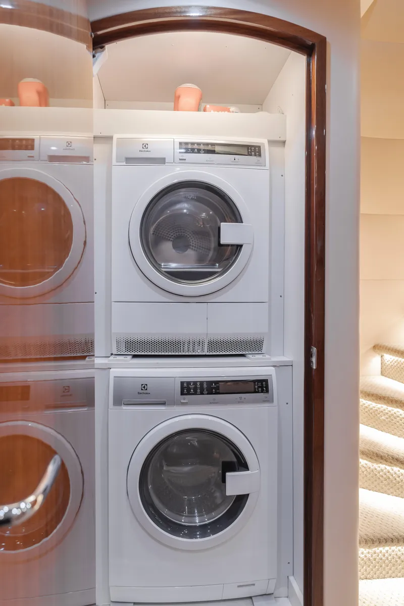 Slide: The Image of Laundry area with stacked washer and dryer on 2006 Hatteras 80 Motor Yacht. - 40