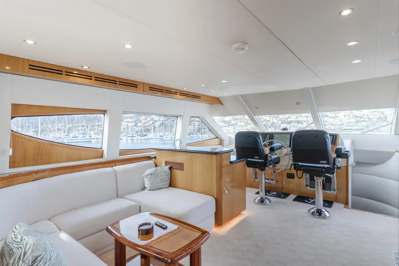 Slide: The Image of Luxurious interior of a 2006 Hatteras 80 Motor Yacht with plush seating and helm. - 41