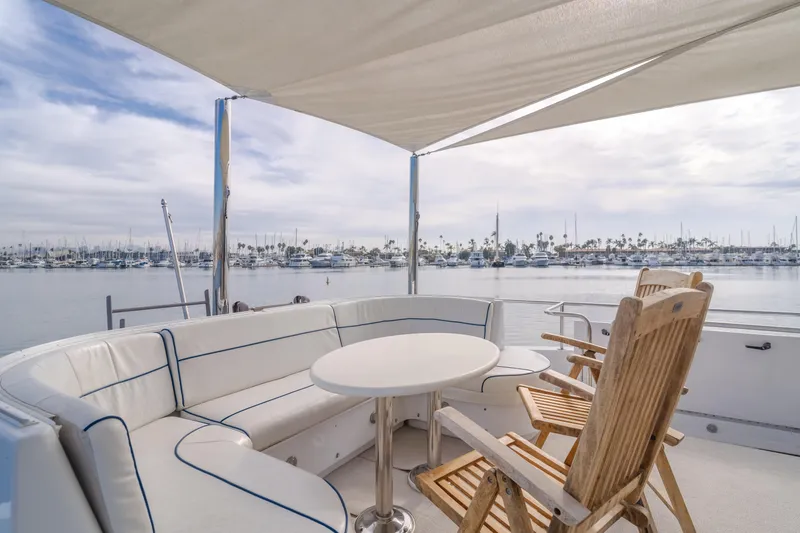 Slide: The Image of Luxury seating area on 2006 Hatteras 80 Motor Yacht, overlooking marina. - 49