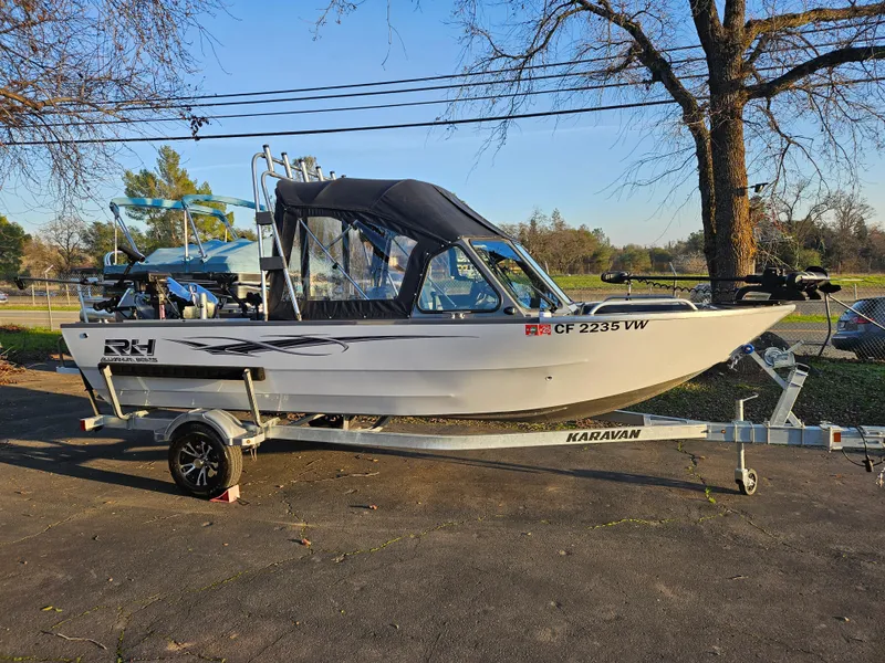 Slide: The Image of 2023 RH Boats 18 Sport on trailer, parked outdoors. - 1
