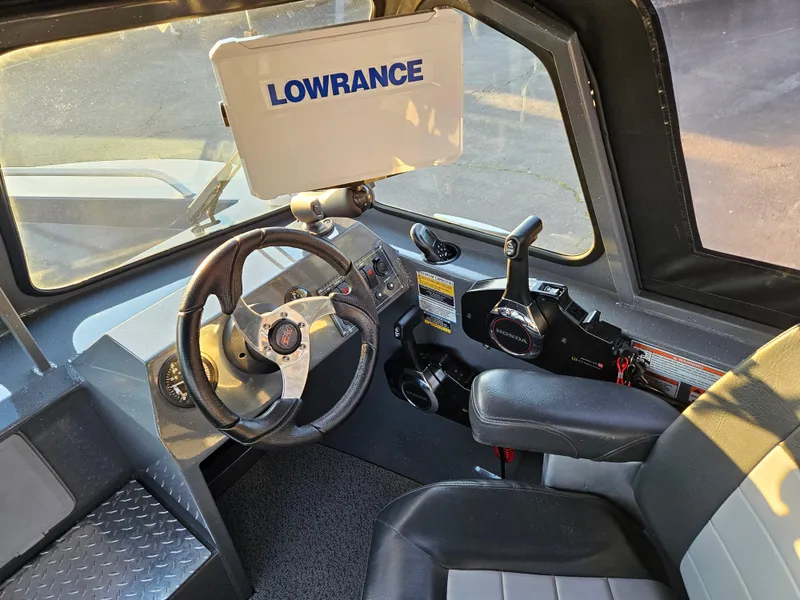 Slide: The Image of 2023 RH Boats 18 Sport cockpit with Lowrance navigation system. - 11