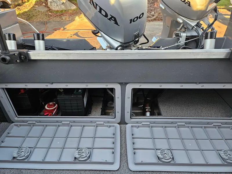 Slide: The Image of 2023 RH Boats 18 Sport with Honda 100 engine, open storage compartments. - 13