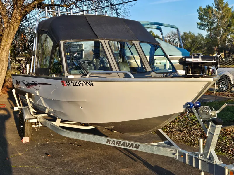Slide: The Image of 2023 RH Boats 18 Sport on Karavan trailer, parked outdoors. - 4