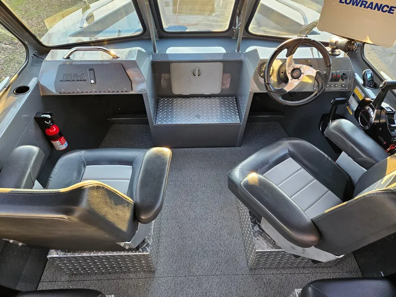 Slide: The Image of 2023 RH Boats 18 Sport interior with dual seats and steering console. - 6