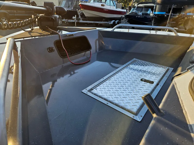 Slide: The Image of 2023 RH Boats 18 Sport deck with storage hatch and equipment. - 8