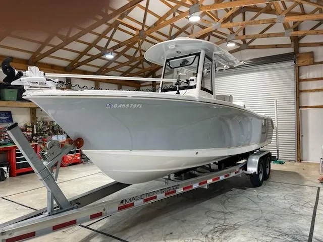 The Image of 2022 Sea Hunt Ultra 255 SE boat on trailer in a garage. - 0
