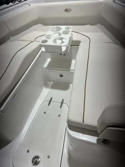 Slide: The Image of 2022 Sea Hunt Ultra 255 SE boat interior with seating and cup holders. - 3