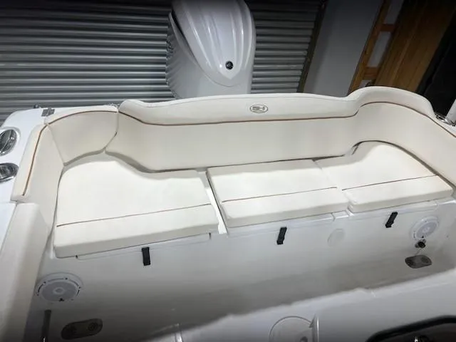 Slide: The Image of 2022 Sea Hunt Ultra 255 SE boat interior with white cushioned seating. - 6