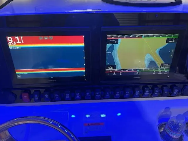 Slide: The Image of Dashboard of 2022 Sea Hunt Ultra 255 SE with navigation and sonar displays. - 9