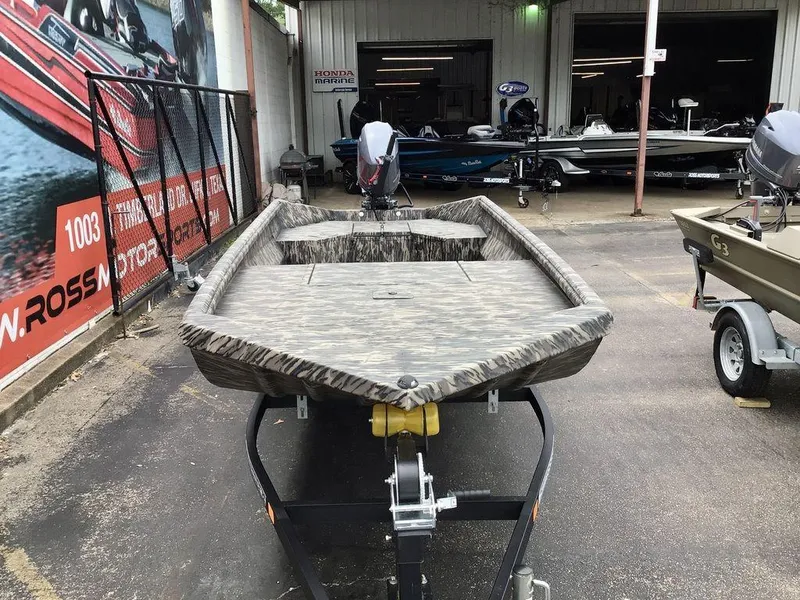 Slide: The Image of 2025 Reaper Boats 656 model displayed on a trailer in a dealership lot. - 10