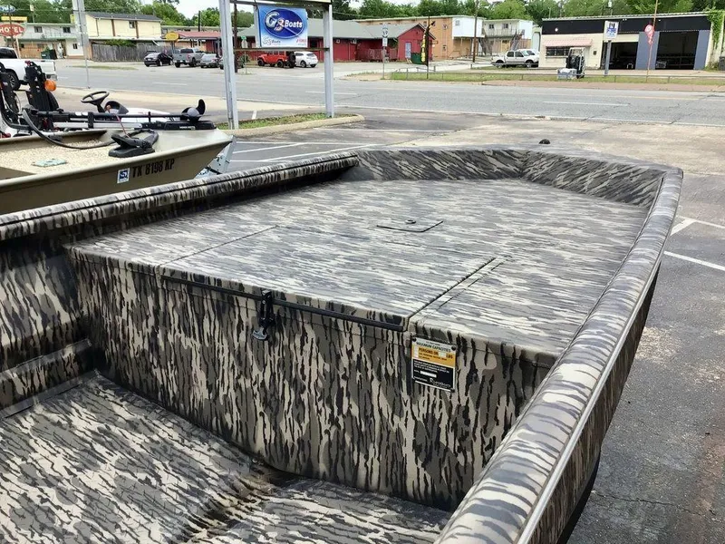 Slide: The Image of 2025 Reaper Boats 656 with camouflage design, parked in a lot. - 12