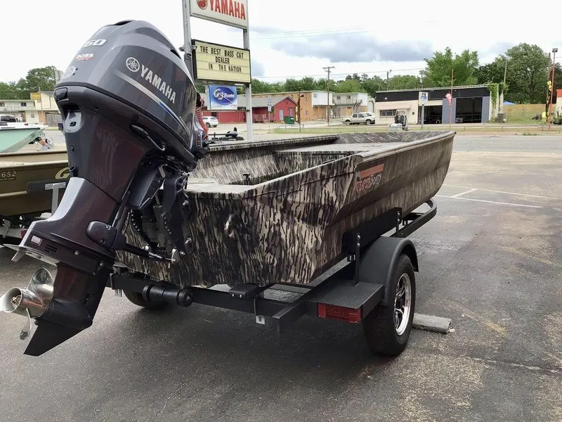 Slide: The Image of 2025 Reaper Boats 656 with Yamaha engine, parked on a trailer in a dealership lot. - 14