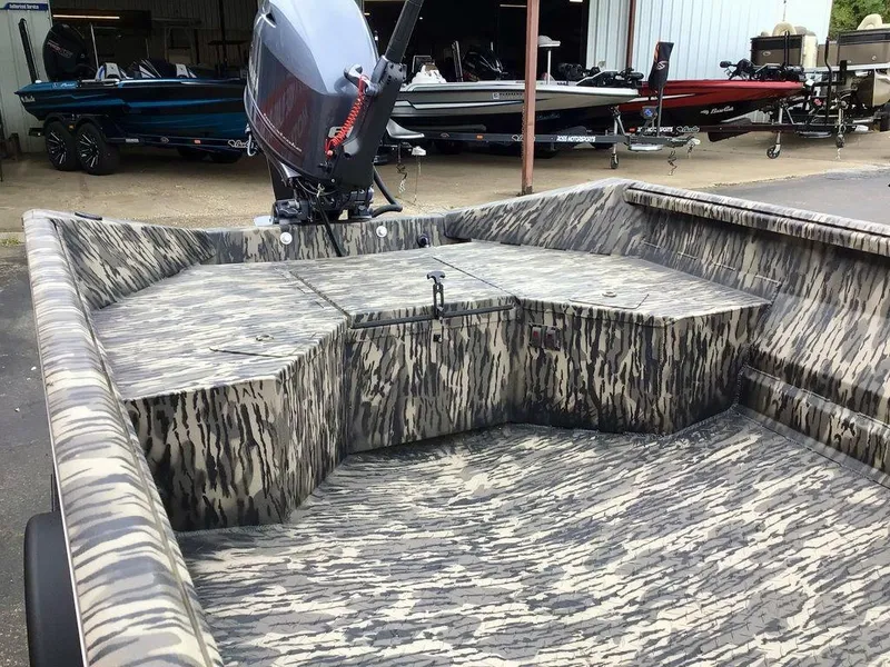 Slide: The Image of 2025 Reaper Boats 656 with camouflage interior and powerful outboard motor. - 19