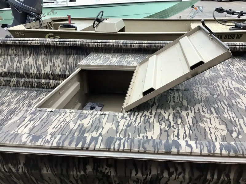 Slide: The Image of Reaper Boats 656 (2025) with open storage hatch, camouflage pattern. - 21