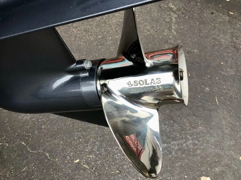 Slide: The Image of Shiny Solas propeller on Reaper Boats 656, 2025 model, displayed on pavement. - 3