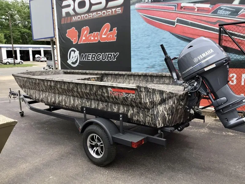Slide: The Image of 2025 Reaper Boats 656 with Yamaha motor on trailer, camo design, at dealership. - 6