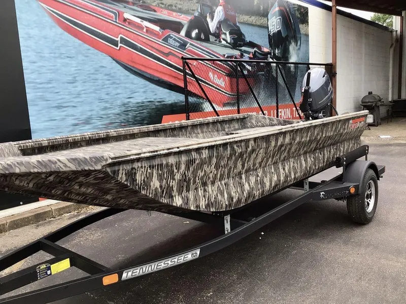 Slide: The Image of 2025 Reaper Boats 656 on trailer, camouflage design, parked outdoors. - 7