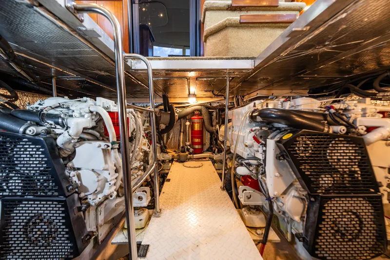 Slide: The Image of Engine room of 2004 Cruisers Yachts 455 Express Motoryacht, showcasing dual engines and equipment. - 33