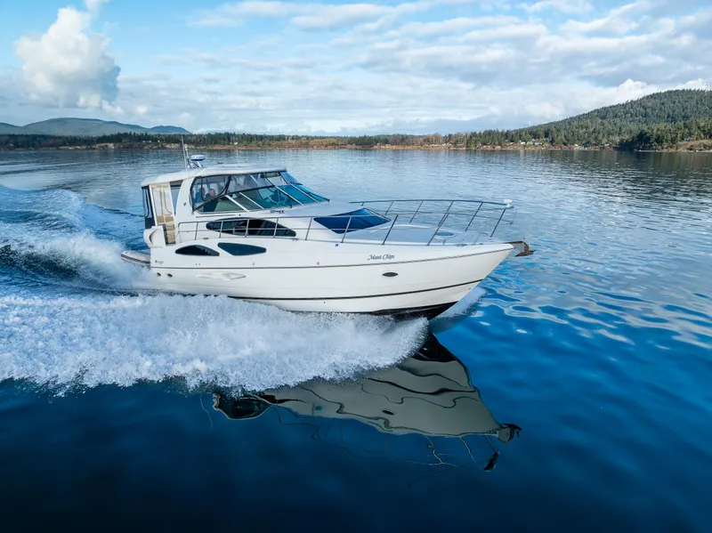 Slide: The Image of 2004 Cruisers Yachts 455 Express Motoryacht cruising on a serene lake. - 40