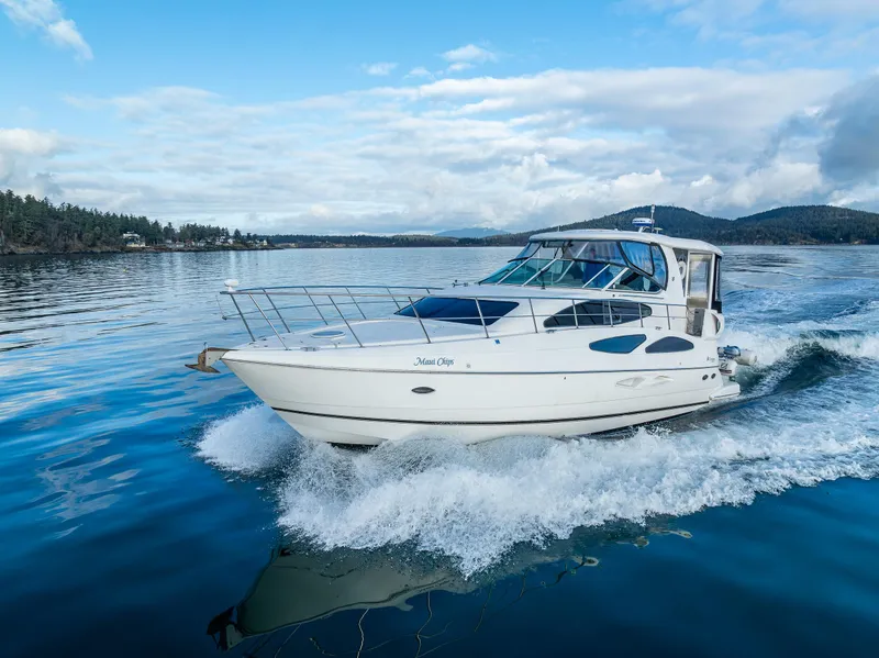 Slide: The Image of 2004 Cruisers Yachts 455 Express Motoryacht cruising on a scenic lake. - 45