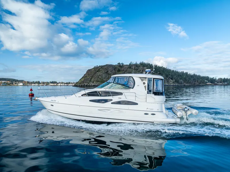 Slide: The Image of 2004 Cruisers Yachts 455 Express Motoryacht cruising on a serene lake. - 46