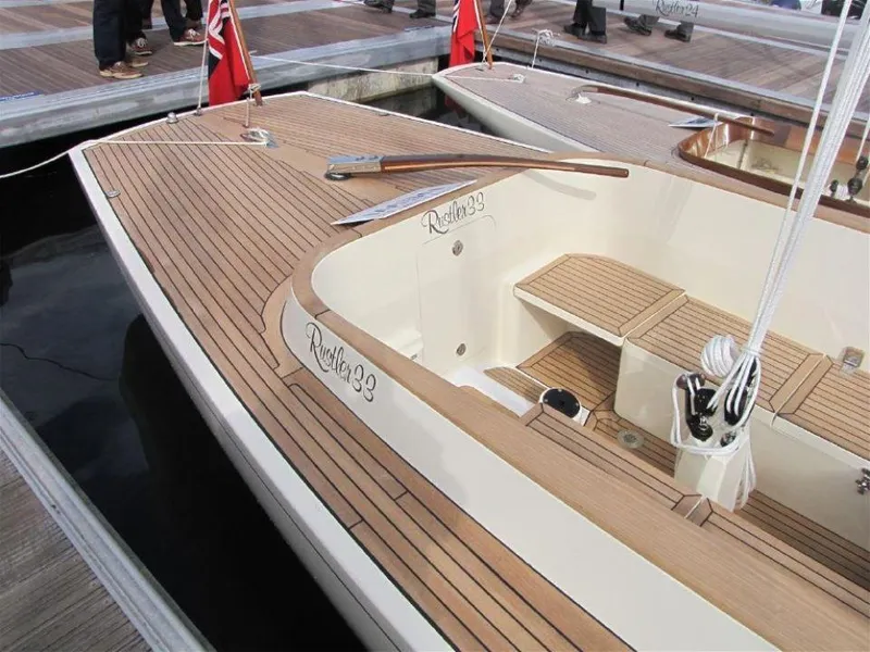 Slide: The Image of 2025 Rustler 33 sailboat with teak deck, docked at marina. - 11