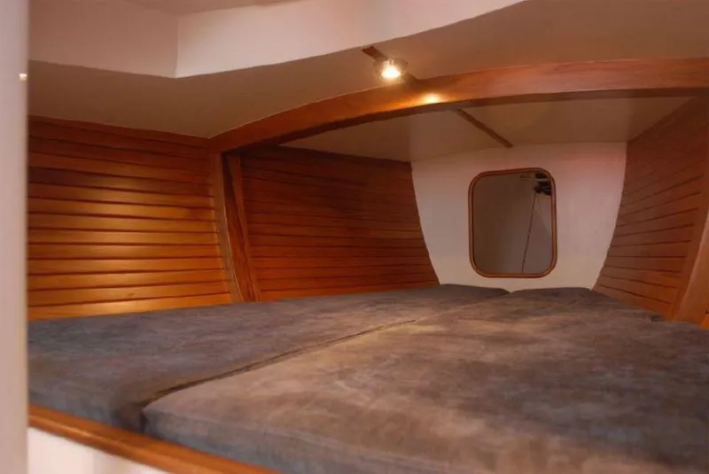 Slide: The Image of Cozy interior cabin of 2025 Rustler 33 sailboat with wooden paneling and soft lighting. - 14