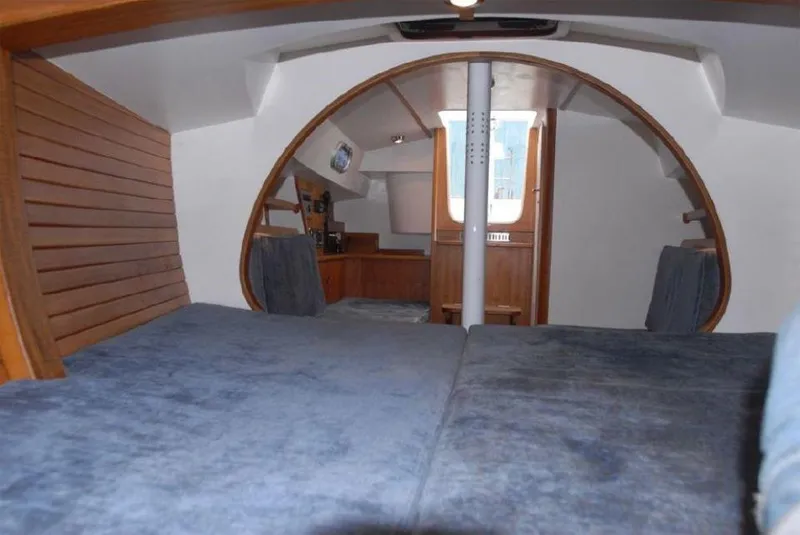 Slide: The Image of Interior of 2025 Rustler 33 sailboat, featuring cozy cabin with wooden accents. - 15