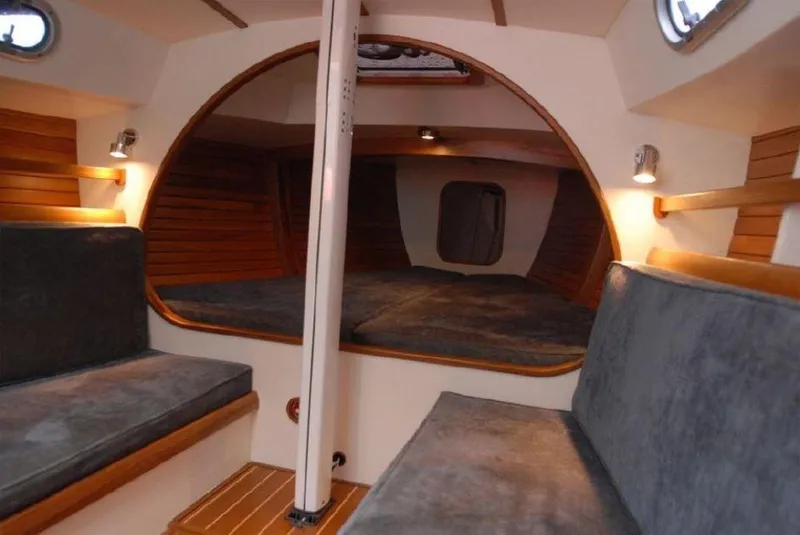 Slide: The Image of Interior of 2025 Rustler 33 sailboat with cozy seating and wooden accents. - 16