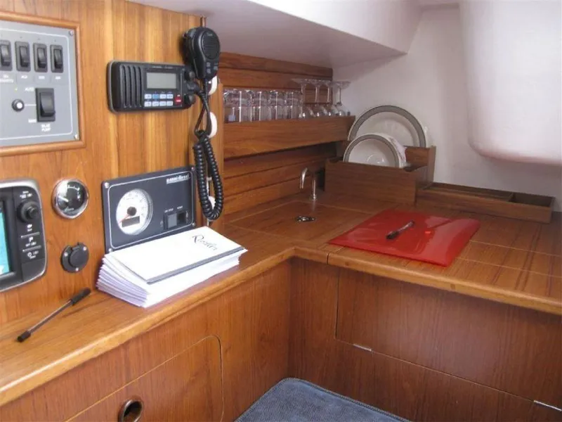 Slide: The Image of Interior of 2025 Rustler 33 yacht with wooden cabinetry and navigation equipment. - 20