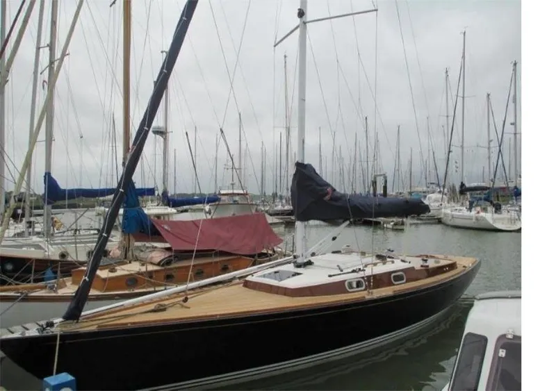 Slide: The Image of Sailboat in marina, Rustler 33 model, 2025, with wooden deck and covered sails. - 6